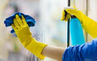 closeup of someone cleaning their inside window with a microfibre cloth